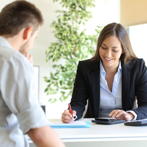 Happy professional agent and customer calculating budget at office