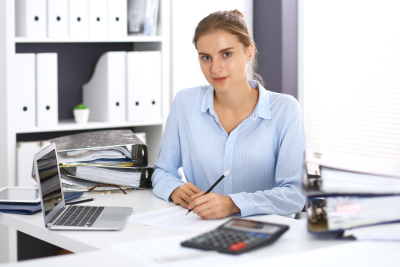 a young woman sitting at a white desk in an office